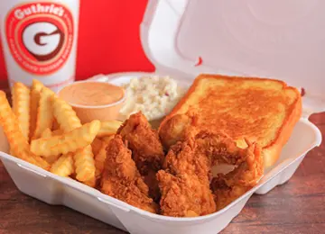 A chicken sandwich, fries and coleslaw in a takeout container.