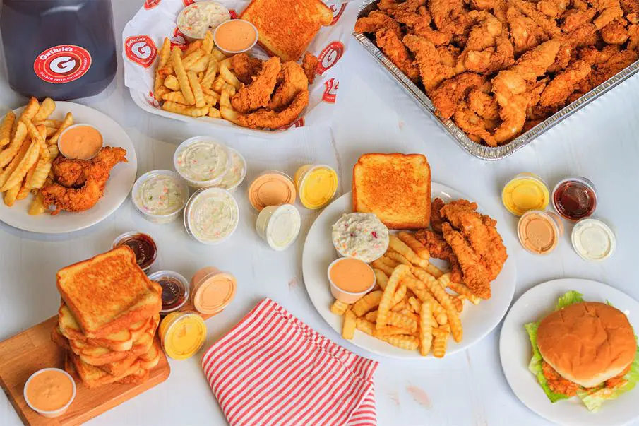 A table filled with plates of food and drinks.